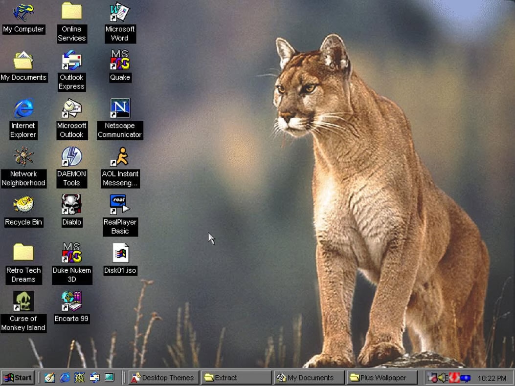 A Windows 98 desktop with a mountain lion wallpaper, surrounded by icons for Quake, Diablo, Duke Nukem 3D, Encarta 99, and AOL Instant Messenger